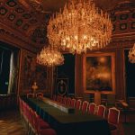 a room with a chandelier and chairs