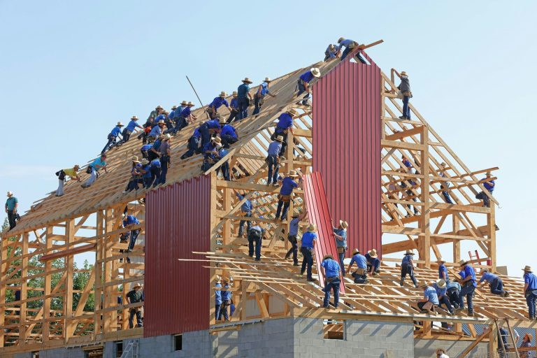 people building structure during daytime