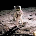 astronaut standing on gray sand