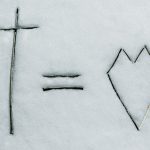 a cross and a line drawn in the snow