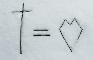 a cross and a line drawn in the snow