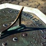 a close up of a metal clock with numbers on it
