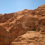 brown rock formations and cave during daytime