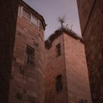 a couple of tall brick buildings sitting next to each other