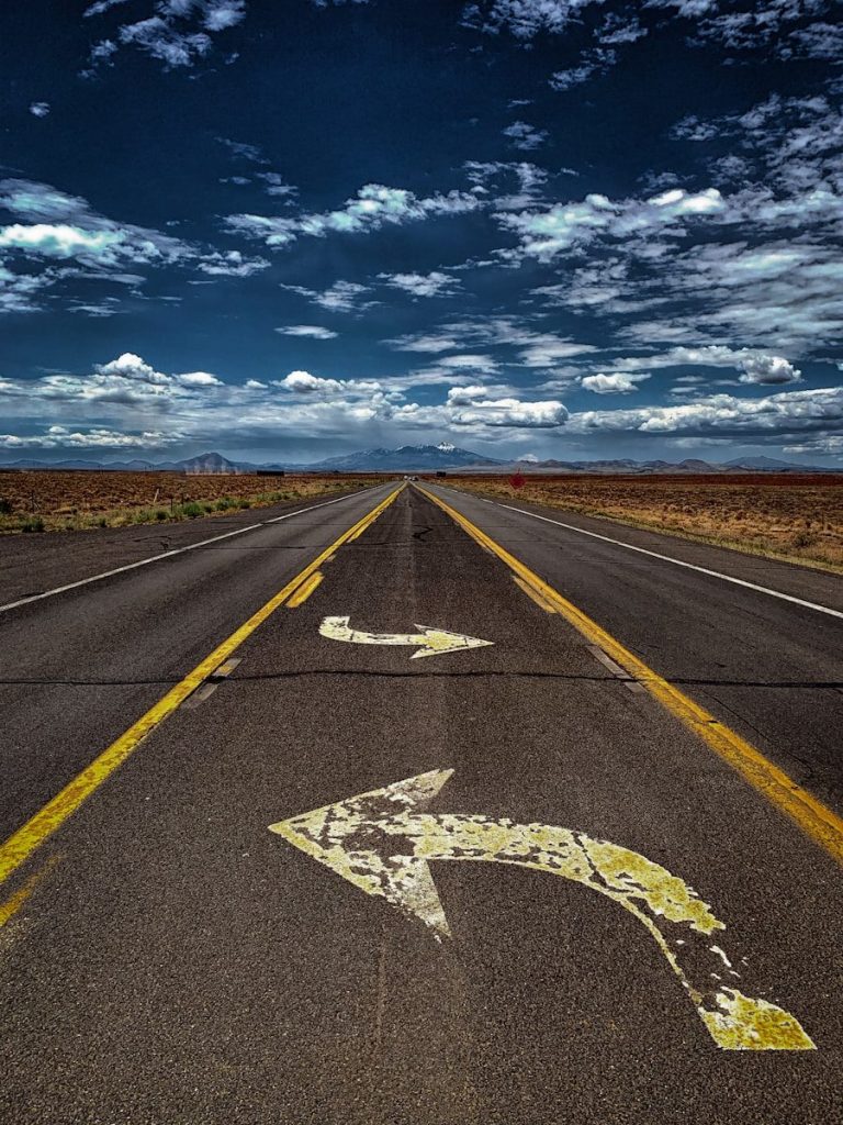 gray asphalt road under blue sky during daytime