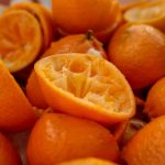 a pile of oranges that are cut in half