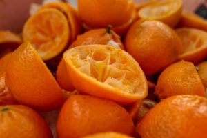 a pile of oranges that are cut in half