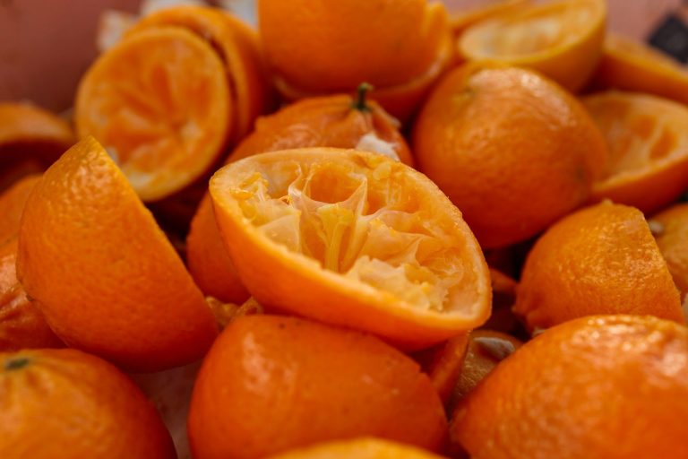a pile of oranges that are cut in half