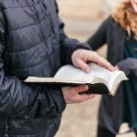 person holding black book