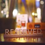 a wooden block that says reserved sitting on a table